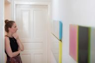 A young woman looks at pictures in a gallery in Munich.