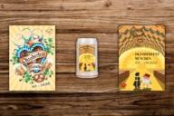 The Oktoberfest posters 2022 and 2021 and the Oktoberfest mug 2022 on a wooden wall