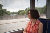 Woman looks out of a tram on the Maximilianstraße in Munich.