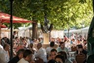 People in a beer garden at the Viktualienmarkt in Munich.