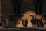 People standing in the shade at the Residenz in Hofgarten in Munich.