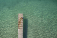Jetty leads into turquoise green water