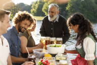 A colorful and cheerful group makes a snack in a Munich beer garden.