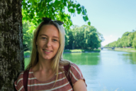 Sarah Althaus stands by a tree on the Nymphenburg Palace canal.