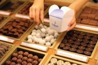 A shop assistant at Dallmayr in Munich is wrapping pralines in box.