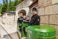 Mother and two children and a driver in the open green mine train of the salt mine in Berchtesgaden