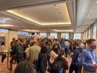 People stand together in small groups and talk at the International Conference on Lymphocyte Engineering.