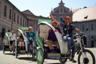 Three pedicaps guides with guests in the courtyard of the Residenz in Munich.