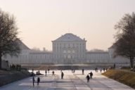 Ice curling rink on the canal in front of Nymphenburg Palace in Munich in winter.