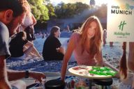 An exhibition stand poster showing a summer scene on the Isar.