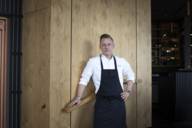Michelin-starred chef Stefan Barnhusen stands with an apron in his restaurant