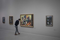 A man is looking at a painting in a museum in Munich.