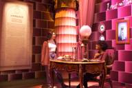 Two teenagers look at a pink backdrop for the Harry Potter exhibition.