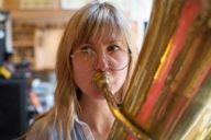 Journalist plays tuba in a music store in Munich.