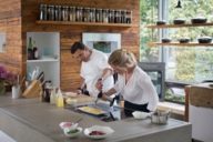 In the cooking school, star chef Christian Jürgens assists the author while flambéing.