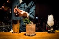 A barkeeper is mixing cocktails in the Flushing Meadows Bar in Munich.