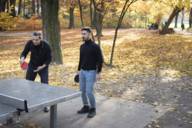 Two men playing table tennis in the Isar meadows in Munich