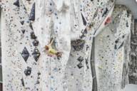 Climber climbing on an artificial rock cone in the outdoor area of a climbing hall.