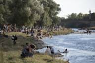 In summer, many people meet on the banks of the Isar river in Munich in the evening.