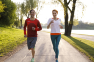 Joggers run in the Olympic Park in Munich.