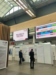 Two people stand at the exhibition of the European Stroke Organisation Conference in Munich.