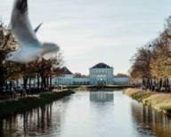 Nymphenburg Palace Canal and Nymphenburg Palace in autumn.