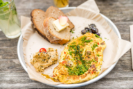 A scrambled egg with bread and butter in the garden salon in Munich.