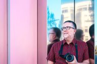 Nicanor García, a professional photographer from Spain, in front of a wall.