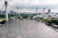 The tent roof of the Olympic Stadium in Munich during cloudy weather.