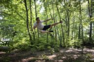 Young man with an action from the Taekwon-Do in a forest in Munich.