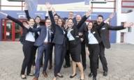 Group of happily waving congress participants