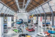 Cars and underground trains are parked in the hall of the transport centre of the Deutsches Museum.