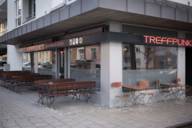The sports bar "Treffpunkt" in Schwabing at dusk from the outside in Munich.