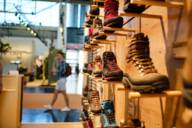 Hiking shoes stand on a shoe rack at OutDoor By ISPO.