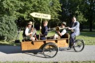 MCA Chairwoman Andrea Bisping and two musicians are cycled by Mayor Josef Schmid to the ProfTreff in Munich.