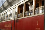 A man with a white beard stands in the Valentin Karlstadt Museum in Munich and laughs.