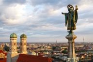 The Münchner Kindl photographed by drone, the towers of the Frauenkirche in the background