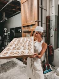 Linda Mutschlechner holds a tin of pretzels in her hand.