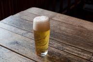 A Helles beer stands on the table of a Munich pub.