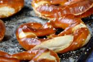Diversi pretzel distribuiti su una teglia da forno.