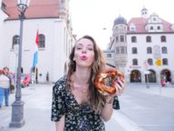 Influencer Sarah Funk with a pretzel in Munich.