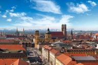 Rooftop view of Munich with the skyline of the Alps in the background. 