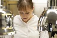 Michelin-starred chef Nathalie Leblond works in a chef's jacket in the kitchen of restaurant Les Deux in Munich.