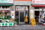 A front door of a residential house between two shops at Landwehrstrasse in Munich.