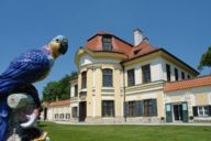 Parrot made out of porcelain in the front garden of the Nymphenburg Porcelain Manufactory in Munich.