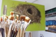 Paintbrushes and paintings in a studio located in the Kreativquartier in Munich.