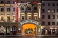 Exterior view of the Deutsche Theater in Munich late at night.