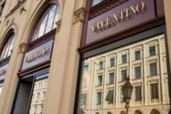 View of house facades at Maximilianstrasse in Munich reflected in the shop window of Valentino.