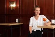 A young woman enjoys a Spritz in a bar in Munich.