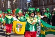 Several people in green costumes celebrate St Patrick's Day on Leopoldstraße in Munich